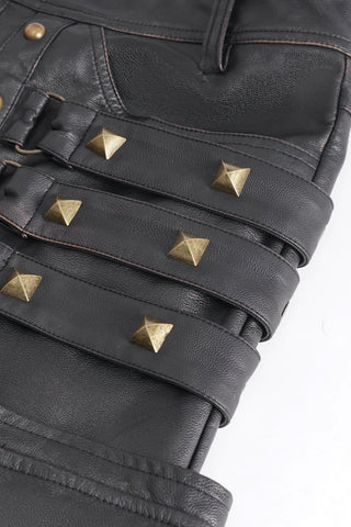 Devil Fashion PT24402 close-up of black faux leather pants with brass pyramid studs and strap detail