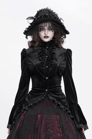 Model wearing a Devil Fashion black velvet Gothic blouse with a ruffled high collar, button front and flared lace-trimmed cuffs.