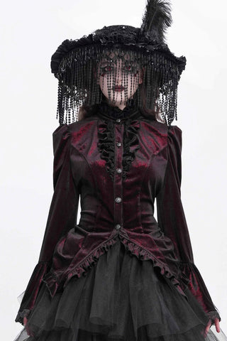 Woman wearing a black and deep red Gothic velvet blouse with a layered black skirt