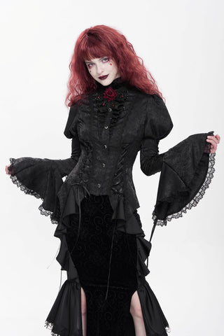 Black Victorian gothic jacquard blouse with bell sleeves, lace-up detailing, puff shoulders and layered ruffle hem worn with a long black velvet skirt.