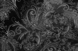 close up of black gothic overcoat brocade fabric pattern detail