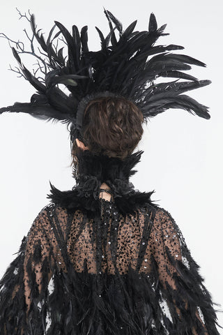 Back view of black feathered headdress and beaded feather cape on mannequin, white background.