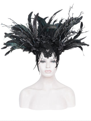 Black feather crown displayed on mannequin head against a white background.