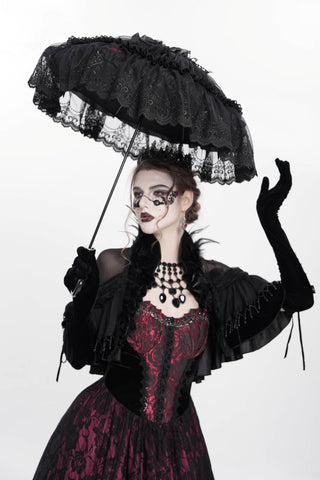 Gothic woman in a black lace parasol and Victorian-style red and black dress, posing against a white background.