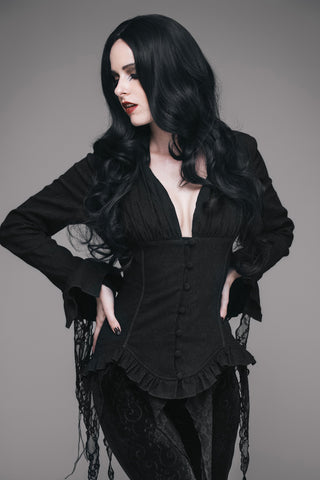 Woman wearing a black Romantic Gothic blouse with corset waist and distressed lace panels