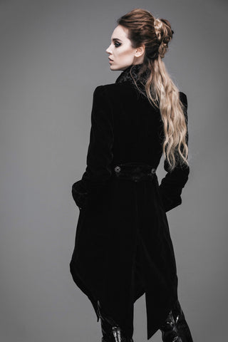 Back view of a woman wearing a Gothic black velvet tailcoat with decorative back belt, pointed hem, and high collar.