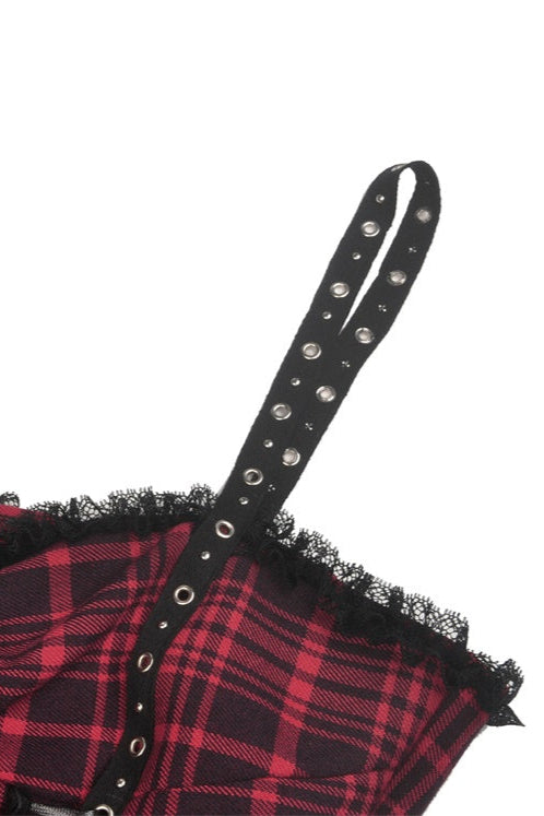 Close-up of lace hem and red plaid fabric on Gothic dress