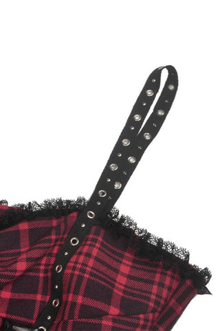 Close-up of lace hem and red plaid fabric on Gothic dress