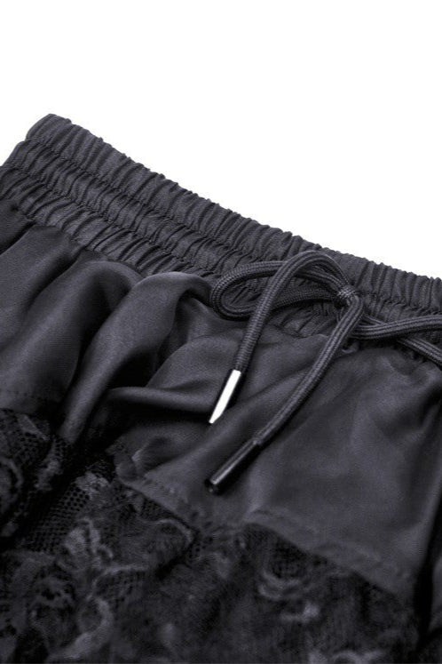 Close-up of elastic waistband and drawstring on black Gothic high-low skirt with lace trim
