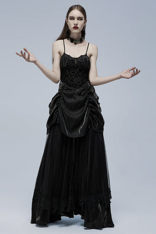 Model posing with arms raised in black Gothic dress