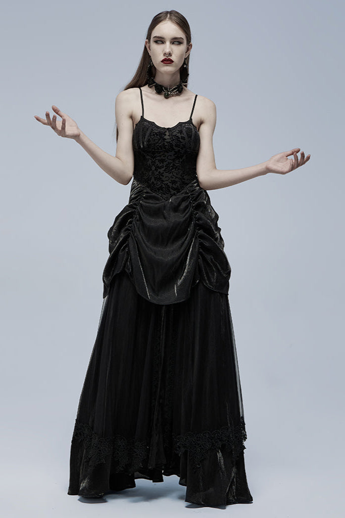 Model posing with arms raised in black Gothic dress