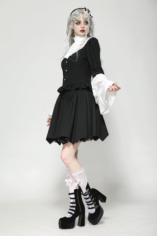 Model wearing Gothic Lolita blouse in black and white – angled pose