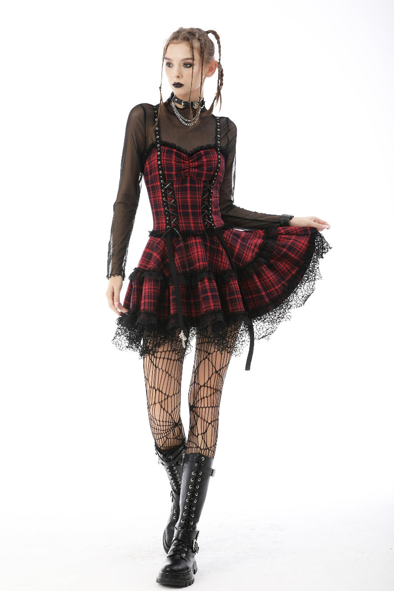 Model in motion wearing red tartan punk dress with mesh sleeves