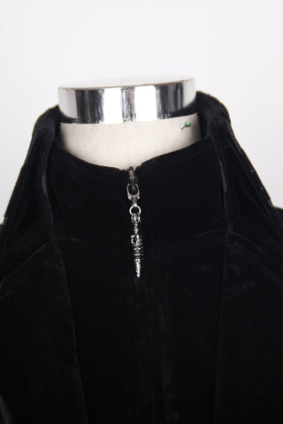 Close-up of Gothic black velvet tailcoat showing high collar and silver-tone pointed zipper pull on a mannequin.