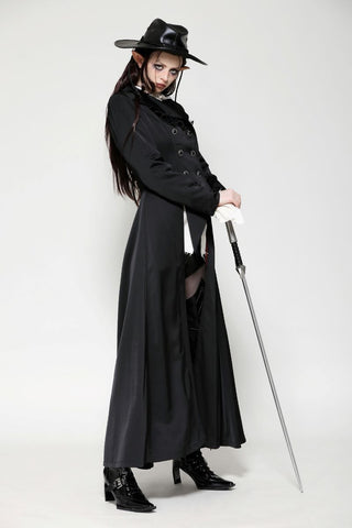 Model in vampire hunter-style coat holding a sword, styled with high boots and hat
