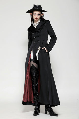 Model wearing long Gothic coat with red lining, hand in pockets, and double-breasted front
