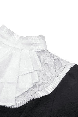 Close-up of white lace collar on black Victorian-style blouse