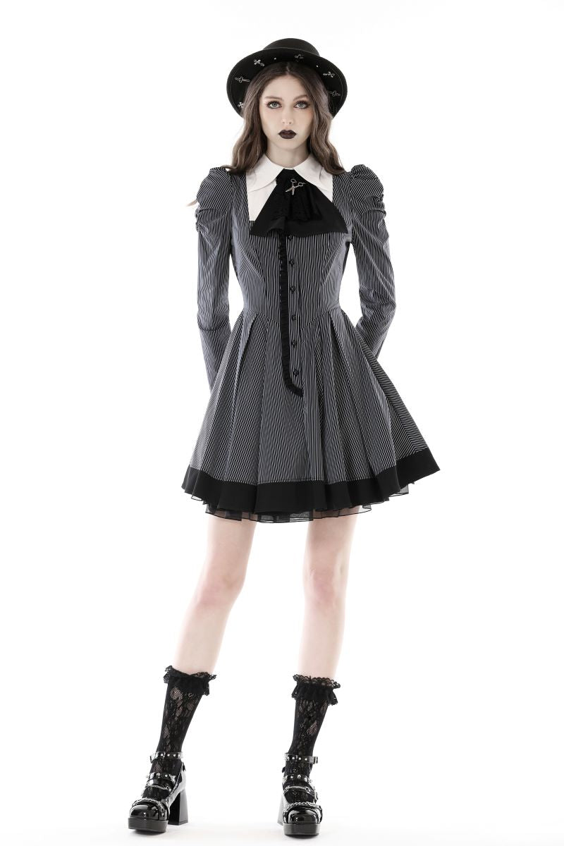 posing in short Gothic pinafore dress with boots