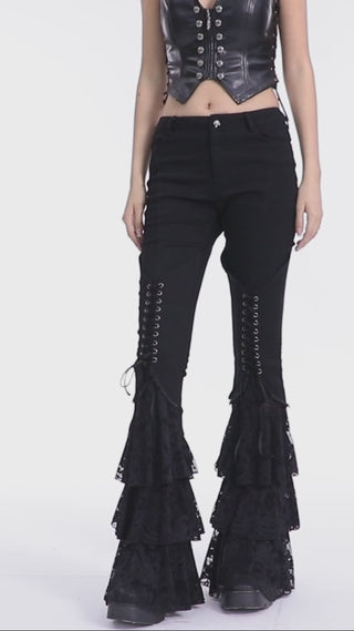 Model showing Punk Rave WK-657 black Gothic flared pants with lace-up front and tiered lace ruffle hems.