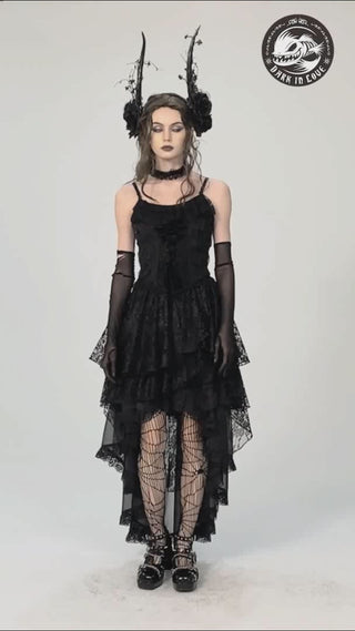 Model showcases the Dark in Love KW263 asymmetric black skirt, walking and turning to highlight its flowing layered hem, side slit, and soft fabric movement. 
