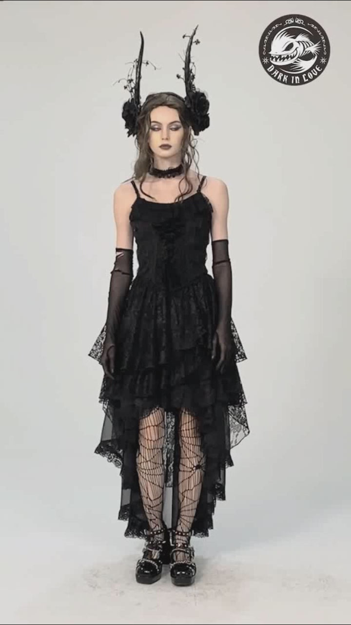 Model showcases the Dark in Love KW263 asymmetric black skirt, walking and turning to highlight its flowing layered hem, side slit, and soft fabric movement. 