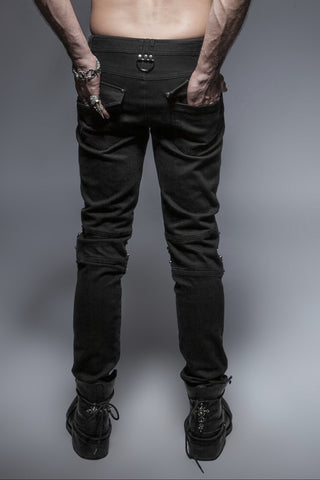 Back view of Punk Rave K-239 men’s black slim-fit pants with panel detailing, strap embellishments above the knees, and a metal D-ring at the waistband, paired with black combat boots against a grey background.