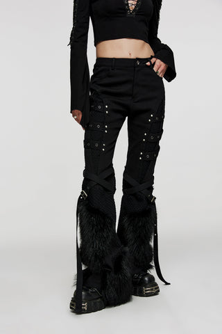 Model wearing black flared Punk Rave WK-526 trousers with faux fur panels, mesh inserts, and decorative straps, styled with a cropped black top