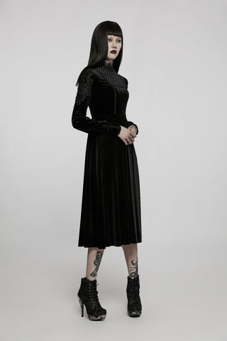  Model in the Punk Rave WQ-586 Romantic Gothic black velvet midi dress, standing in a side pose with hands clasped, wearing high-heeled lace-up boots against a light grey background.