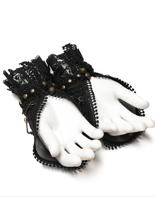 Pair of black lace wrist cuffs with layered ruffles, gold bead accents, and decorative chains, displayed on white mannequin hands against a white background.