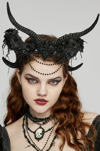 Black Gothic horn headpiece with curved demon horns, floral details and draped bead chains worn by a model