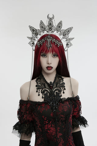 Model wearing Punk Rave WS-737 Gothic halo crown with silver skull accents, spiked arcs, and chain details, styled with a red and black off-shoulder lace dress and ornate black necklace.