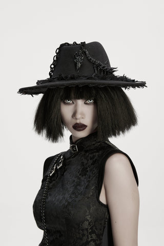 Model wearing a black Gothic hat with lace trim, chain details, and dragon bone accents paired with a brocade dress.