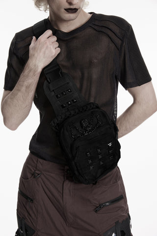 Model wearing black cyber goth utility sling bag with skull chain hardware and adjustable crossbody strap