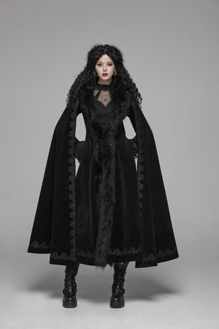 Model wearing punk tsbr wy-1035 a black Victorian Romantic Gothic velvet coat with faux fur trim and extra-long split sleeves, standing on a grey background."