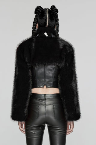Back view of model wearing black faux fur bolero jacket over a leather corset and high-waisted leather pants, on a grey background
