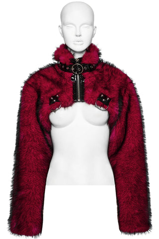 Cropped red faux fur bolero jacket with black PVC buckles and high collar, displayed on a white mannequin against a plain background.