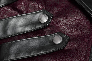 Close-up of two black faux leather strap accents with silver PUNK RAVE buttons, stitched over dark maroon textured lace fabric.