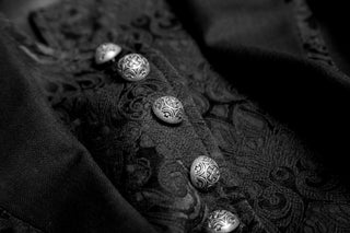 Victorian gothic jacket detail with textured fabric and metal buttons