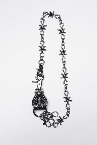Barbed wire-style silver keychain with spider clasp laid flat on a white background.