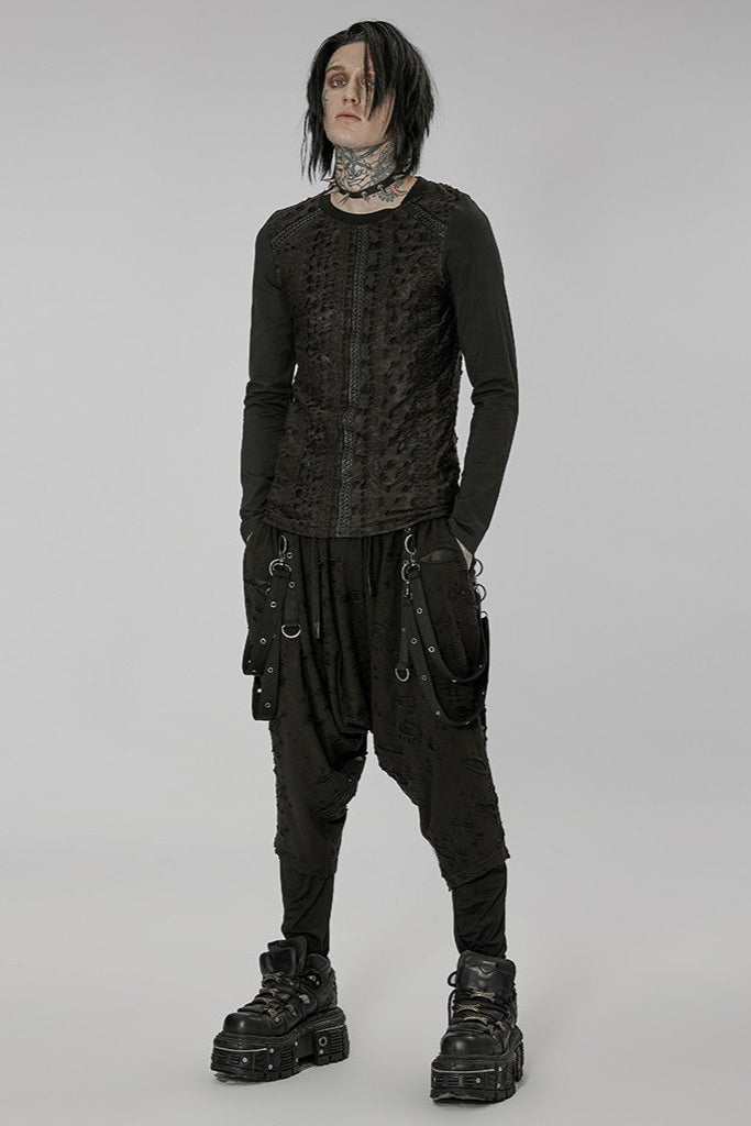 Full-body view of model wearing black dropcrotch pants with harness straps