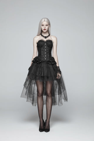 Full-length model wearing a black corset top and layered high-low tulle skirt with sheer tights and heels on a white studio background.