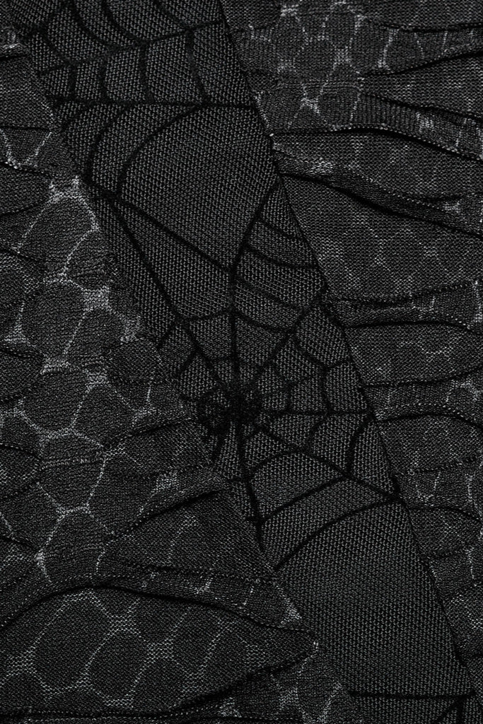 Extreme close-up of black spiderweb lace and distressed mesh fabric texture on Gothic top