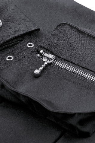 Close-up view of black techwear mini skirt zippered utility pocket with metal eyelets and decorative pull chain.