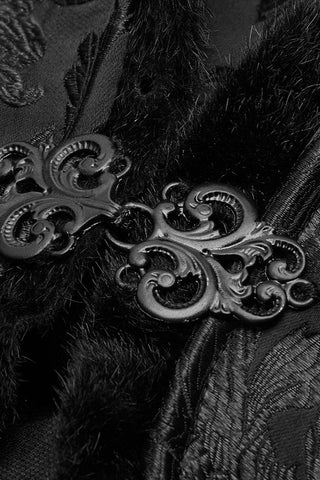 Close-up of metallic clasp detail on black velvet cloak