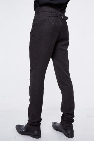 Close-up of decorative rear lacing and jacquard fabric on high-waisted Gothic trousers