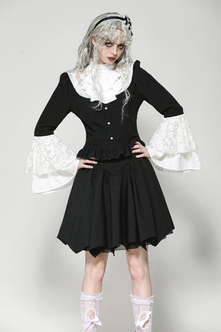 Model wearing black and white Victorian Lolita blouse with lace bell sleeves – front view