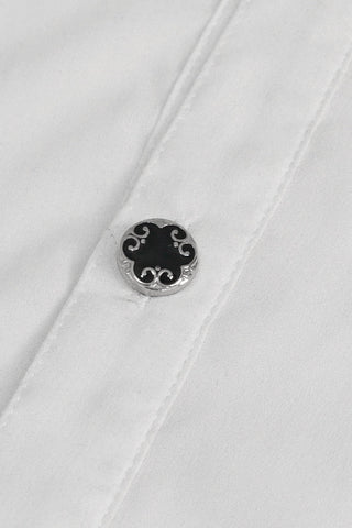 Close-up of black Victorian-style button with silver ornamental design on white shirt