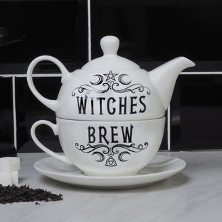 Witches Brew teapot and cup set with matching saucer on a kitchen counter