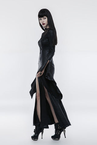 Side walking view of model in black fitted Gothic dress with high slit and bell sleeve